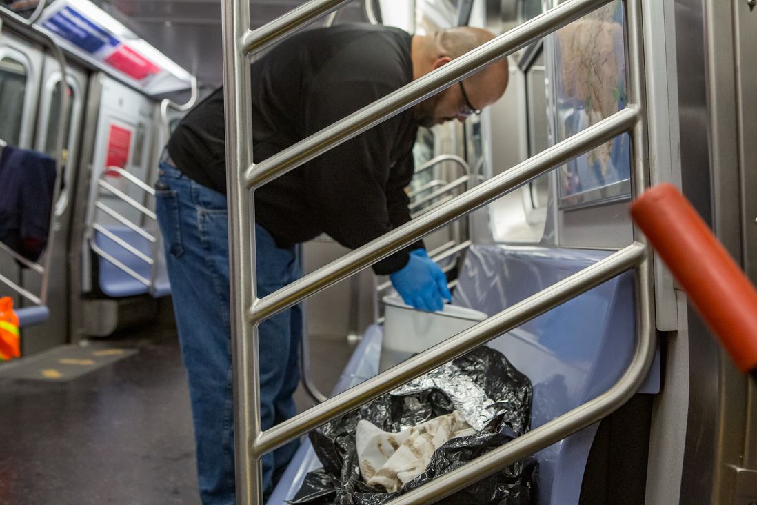 MTA transit workers clean a subway station in Brooklyn as well as a subway car.